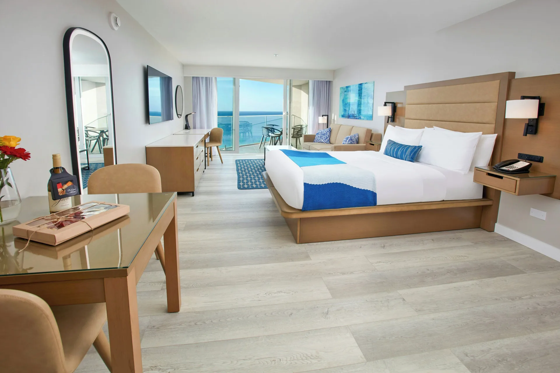 Studio Suite king bed and balcony view at Divi Aruba Phoenix Beach Resort.