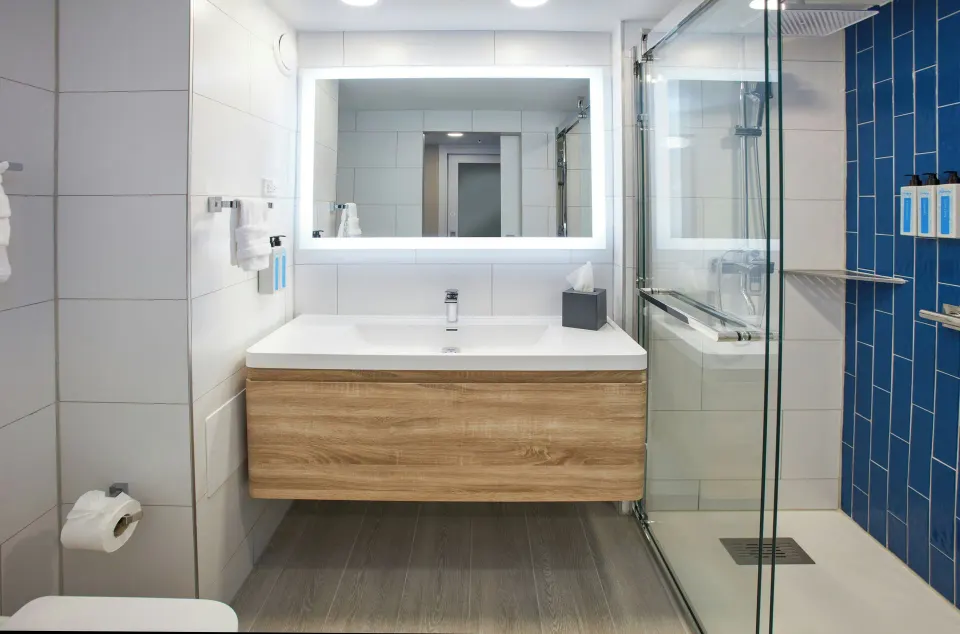 One-bedroom suite bathroom with glass shower at Divi Aruba Phoenix Beach Resort.
