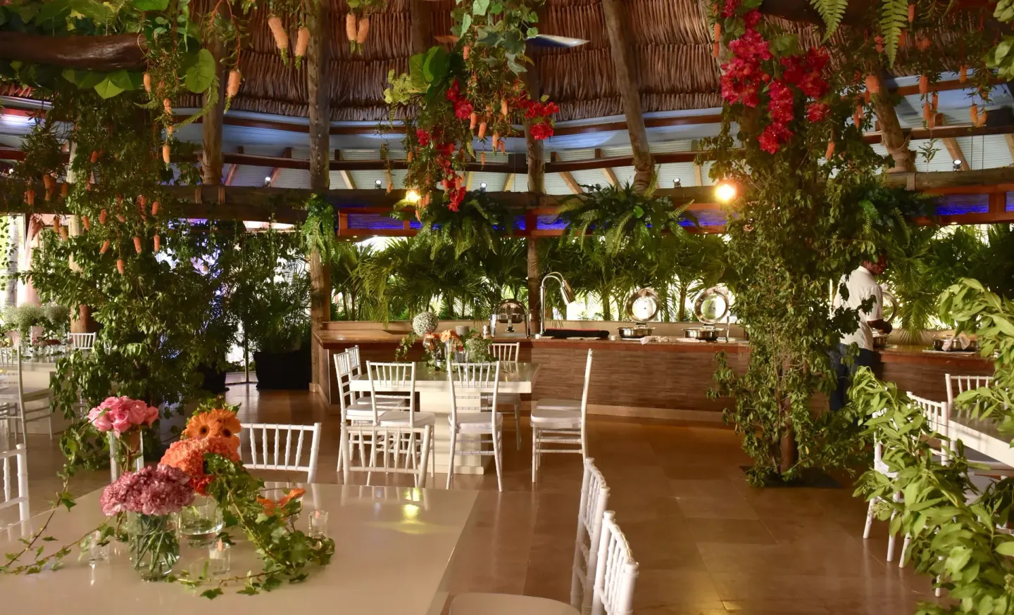 Event dining setup with white chairs and greenery at Divi Aruba Phoenix Beach Resort.