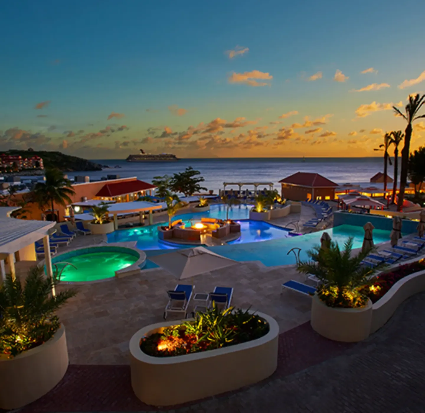 Evening pool scene with ocean horizon at Divi Little Bay Beach Resort.
