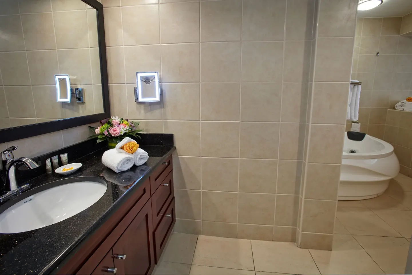 Bathroom vanity and jetted tub in a guest room at Divi Little Bay Beach Resort.
