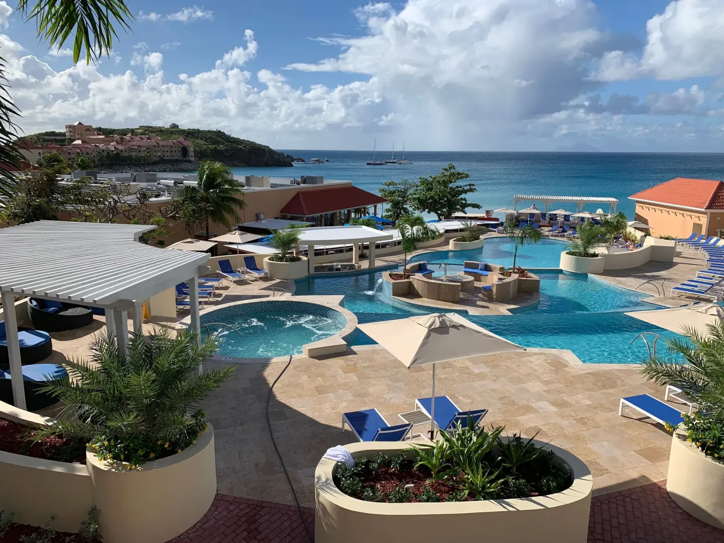 Main pool area with ocean and hillside views at Divi Little Bay Beach Resort.