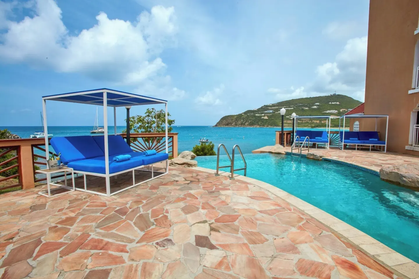 Poolside cabanas overlook the turquoise bay at Divi Little Bay Beach Resort.