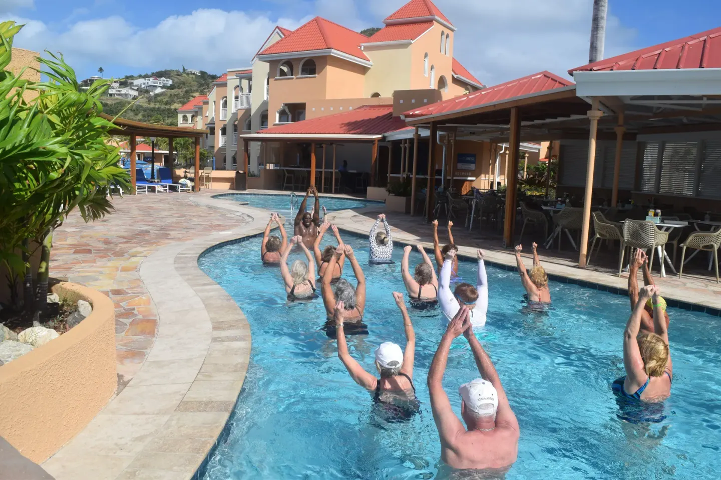 Guests doing water exercise in the pool at Divi Little Bay Beach Resort.