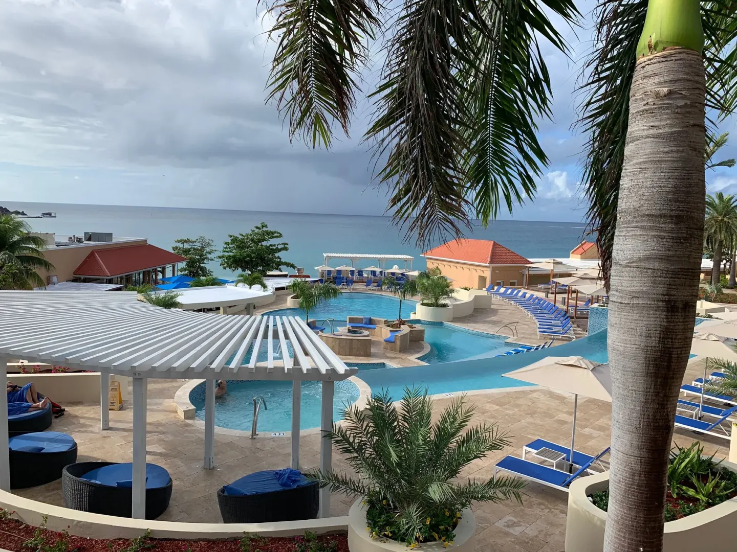 Resort pool deck overlooking the sea at Divi Little Bay Beach Resort.