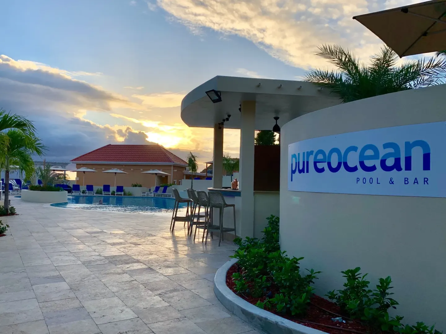 pureocean Pool Bar sign beside the pool at Divi Little Bay Beach Resort.
