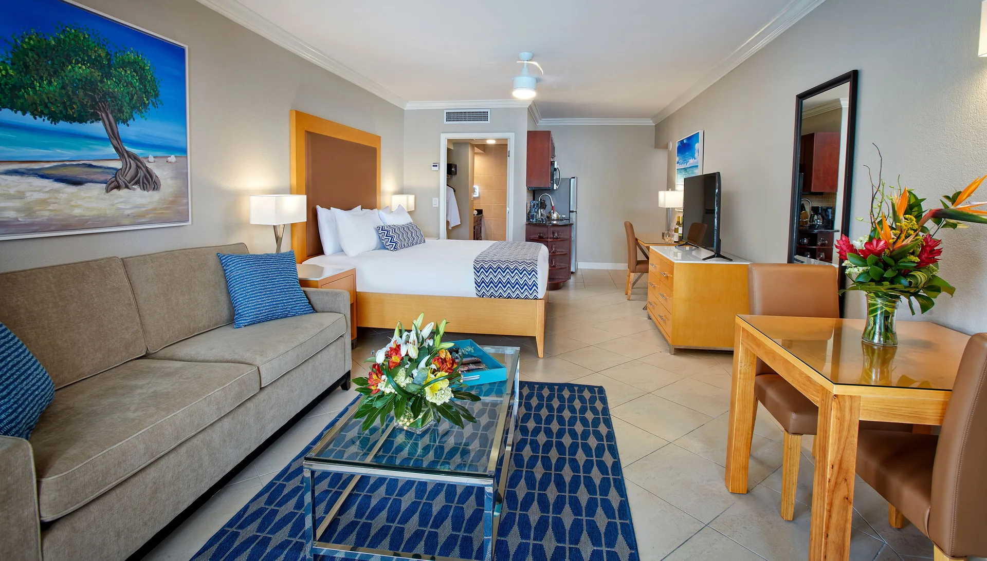Studio Suite with king bed, sofa and dining table at Divi Little Bay Beach Resort.