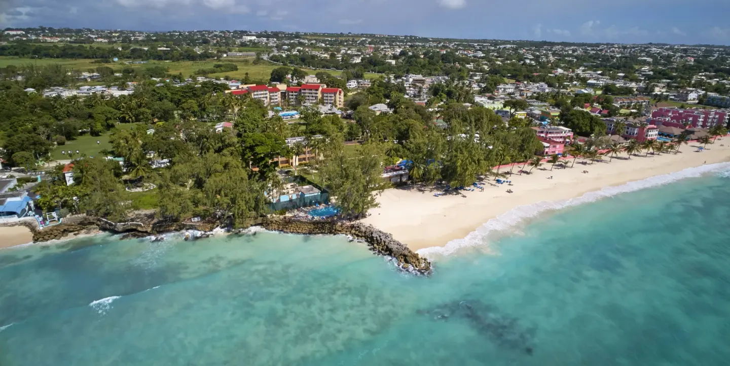 Aerial coastline view with beach and turquoise water near Divi Southwinds Beach Resort.