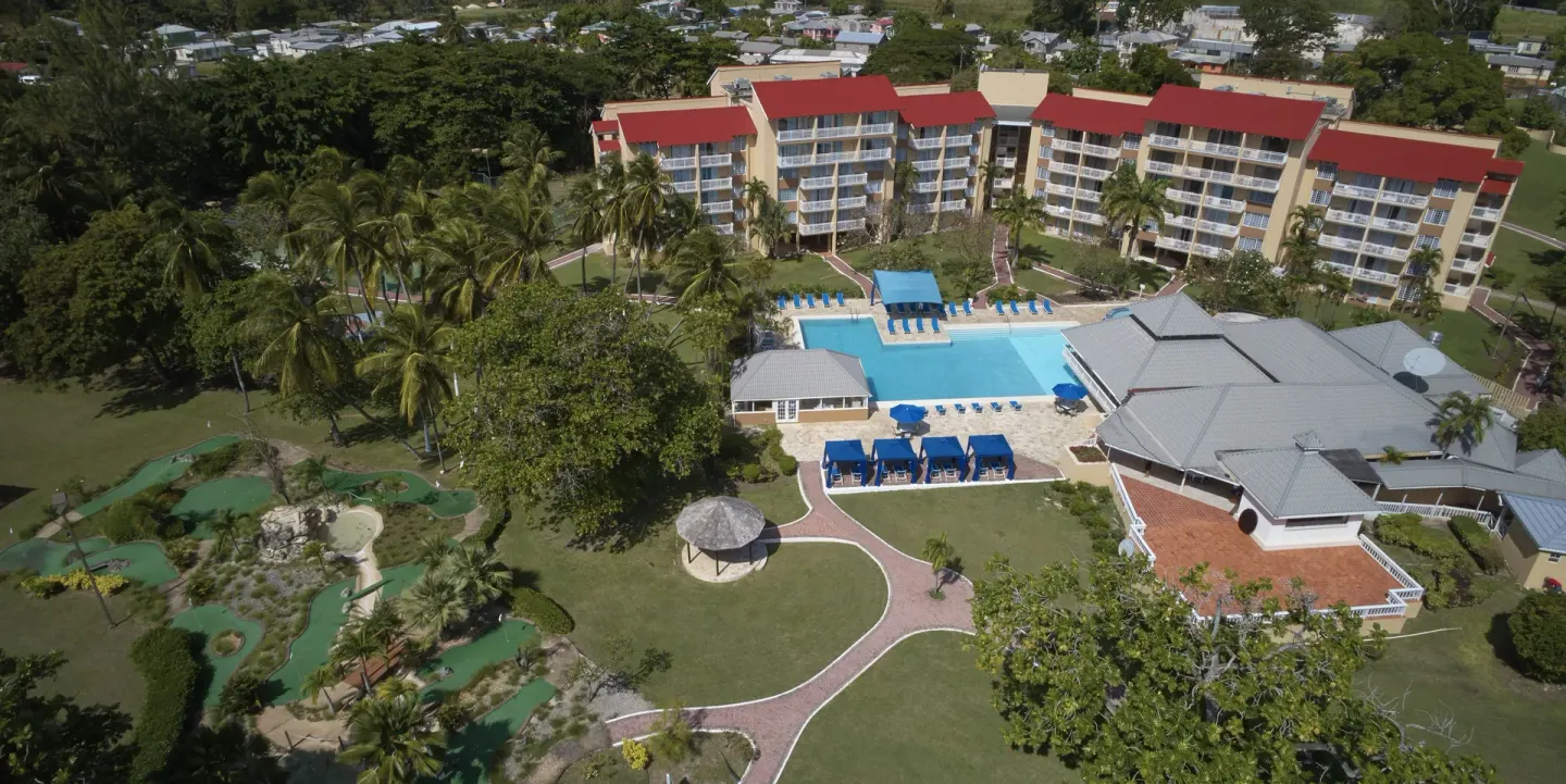 Aerial view of pool, gardens, and resort buildings at Divi Southwinds Beach Resort.
