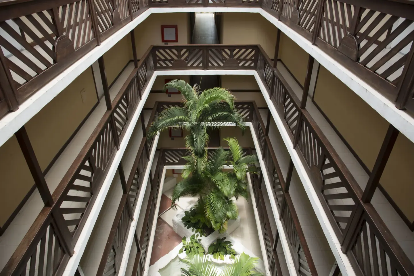 Open-air corridor atrium with palms at Divi Southwinds Beach Resort.