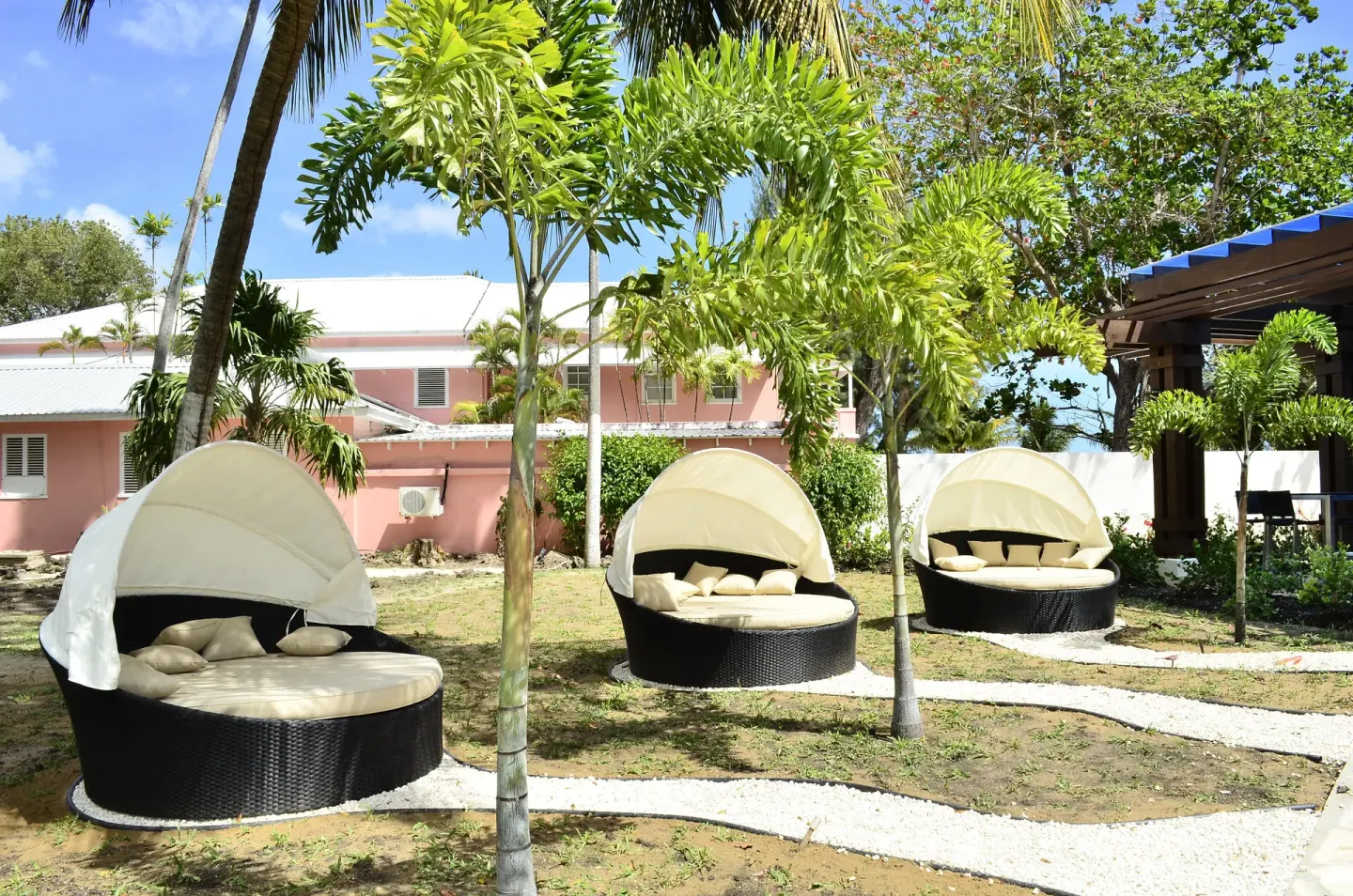 Canopied round loungers in a tropical garden at Divi Southwinds Beach Resort.