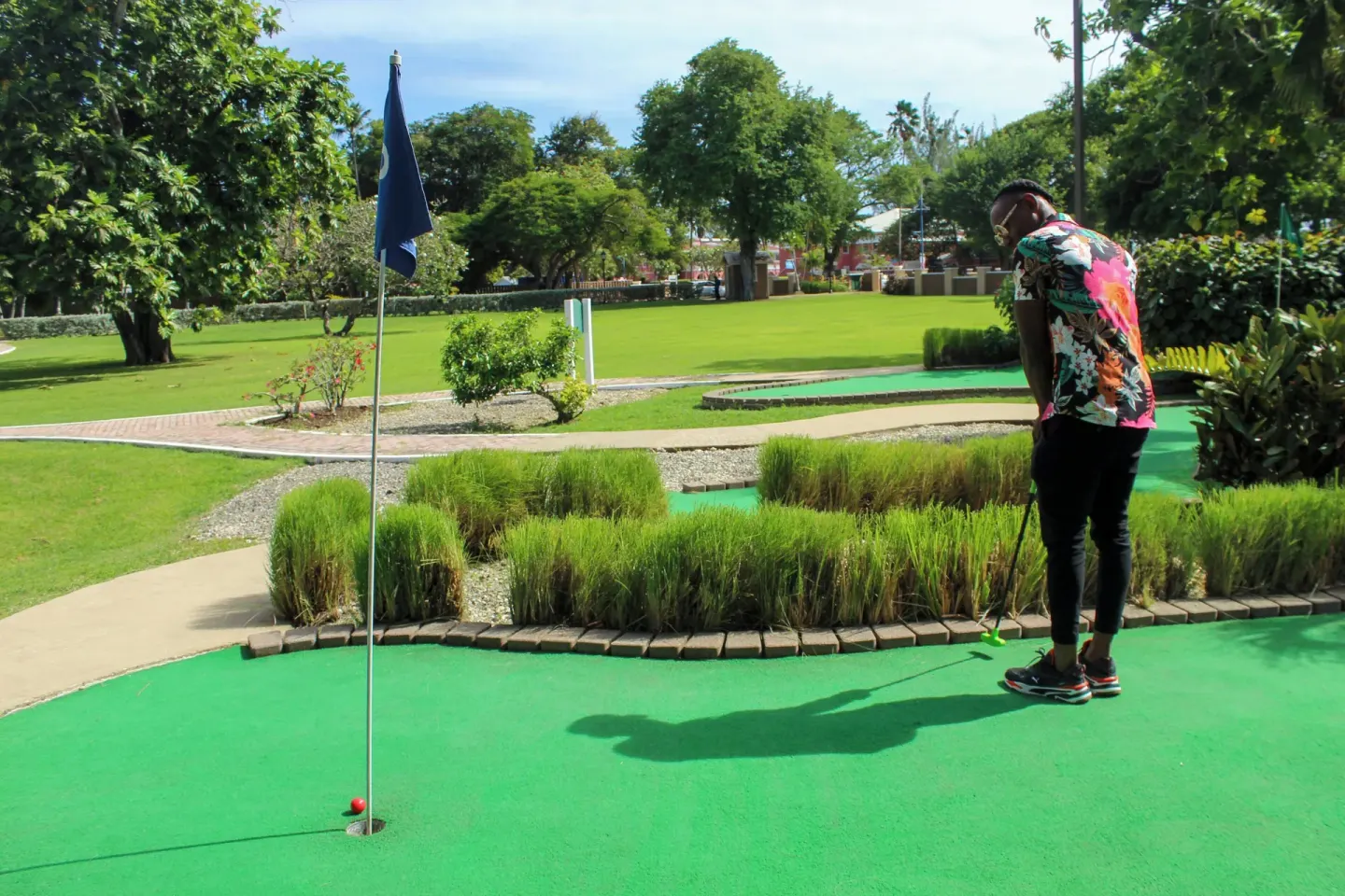 Guest putting on a mini golf green at Divi Southwinds Beach Resort.