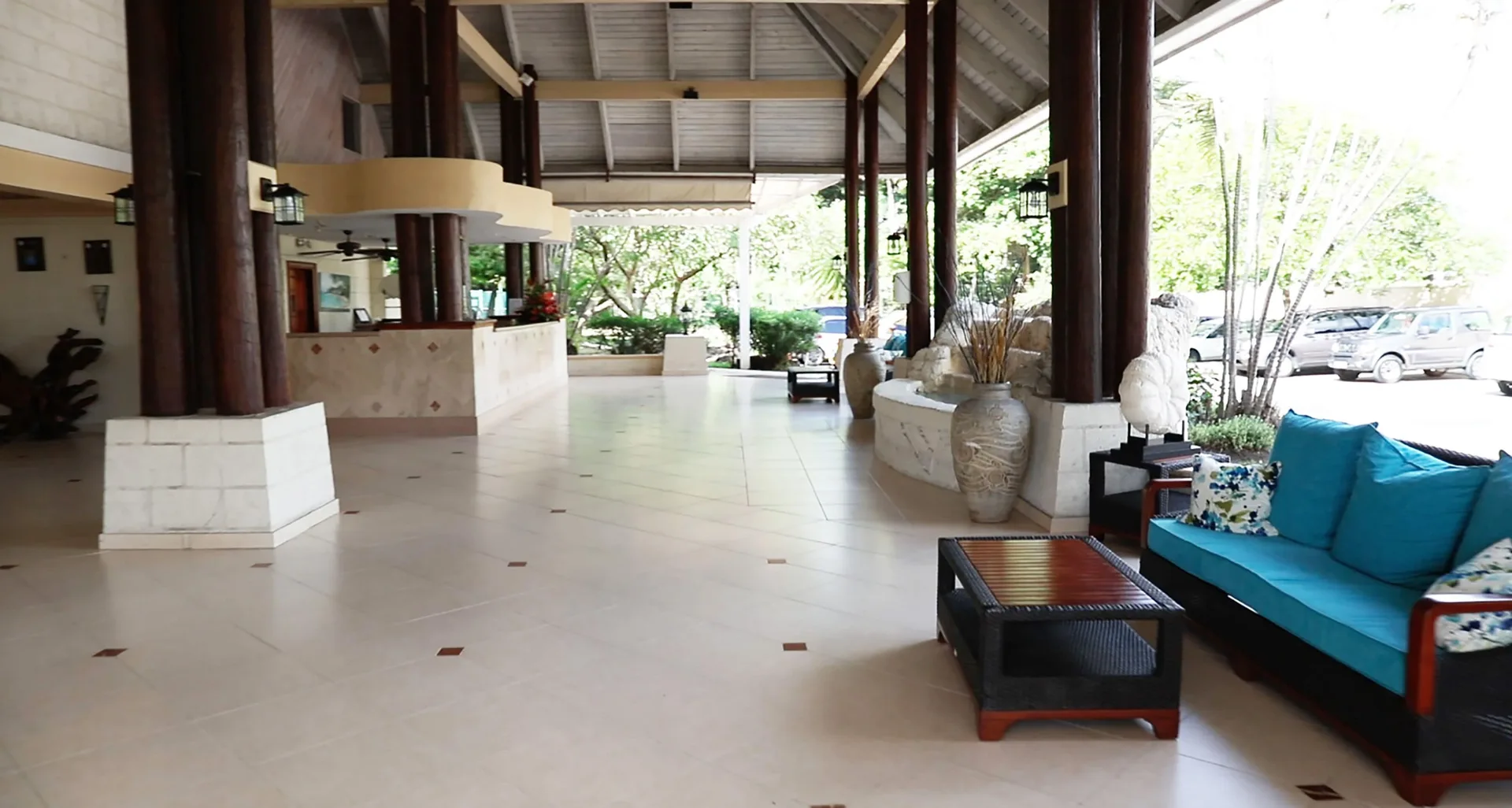 Open-air lobby with turquoise seating and dark columns at Divi Southwinds Beach Resort.