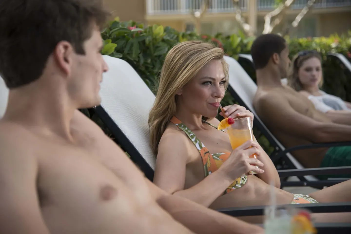 Guests lounge poolside with tropical drinks at Divi Southwinds Beach Resort.