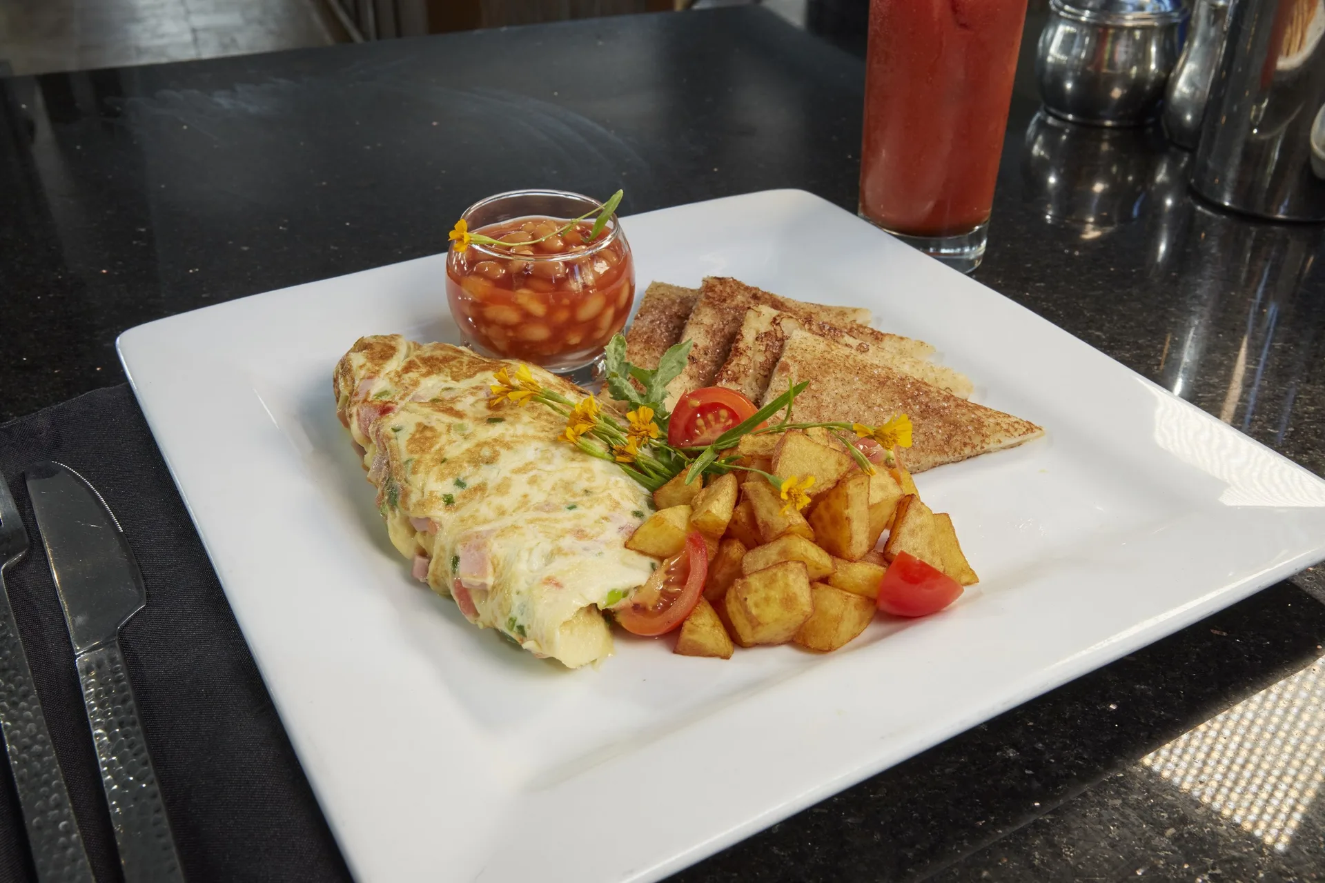 Plated omelet breakfast with potatoes, toast, and beans at Divi Southwinds Beach Resort.