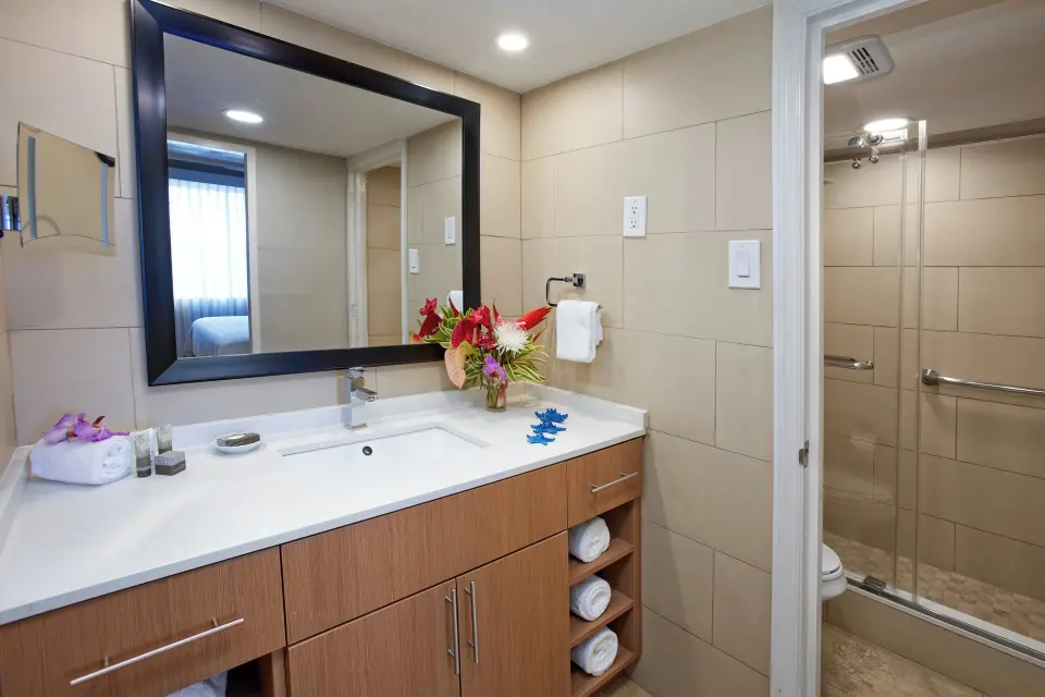One-bedroom garden view suite bathroom vanity and shower at Divi Southwinds Beach Resort.