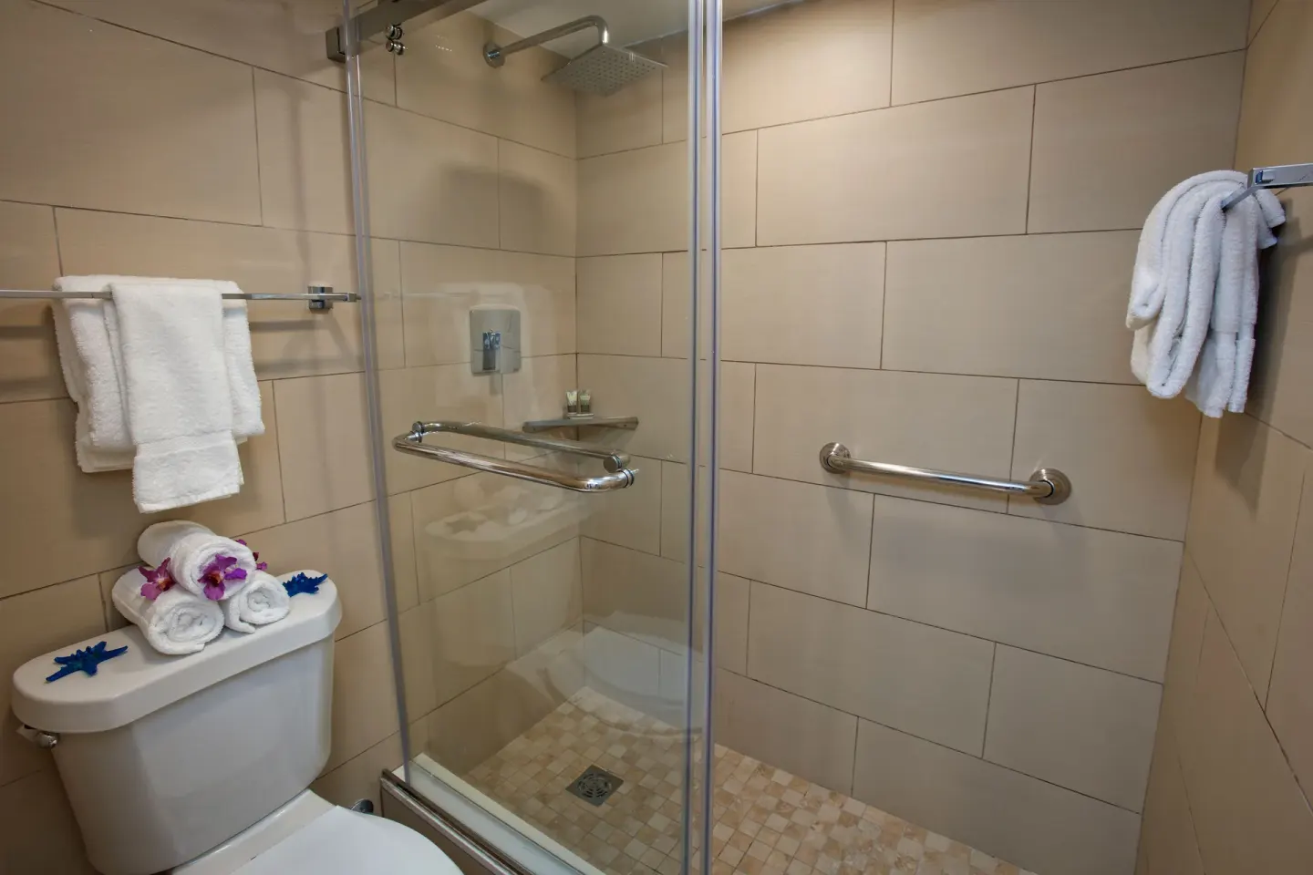 Suite bathroom shower with glass door and towels at Divi Southwinds Beach Resort.