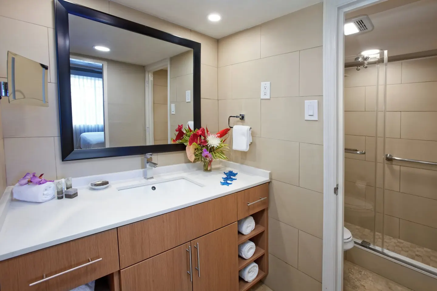 Suite bathroom vanity with mirror and shower doorway at Divi Southwinds Beach Resort.