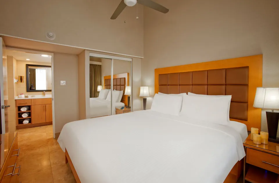 One bedroom pool view suite with king bed and vanity at Divi Southwinds Beach Resort.