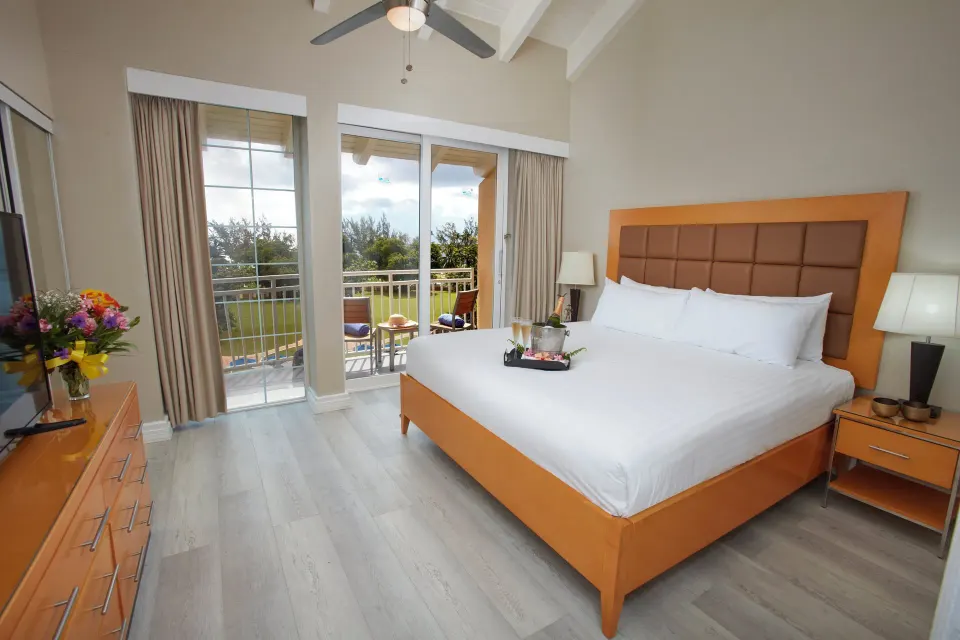 King bedroom with balcony seating in a two-bedroom suite at Divi Southwinds Beach Resort.