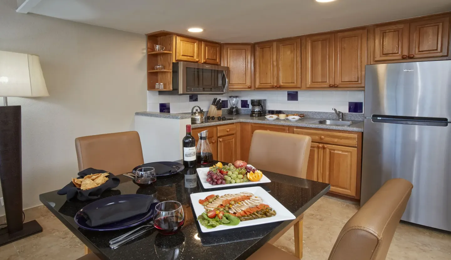 Suite kitchen and dining table set with food at Divi Southwinds Beach Resort.