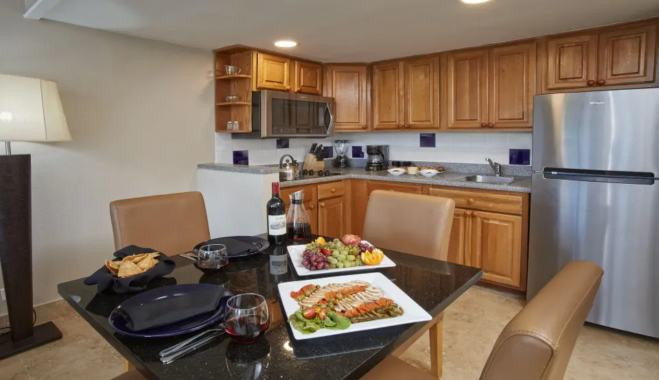 Suite kitchen and dining table set with food at Divi Southwinds Beach Resort.