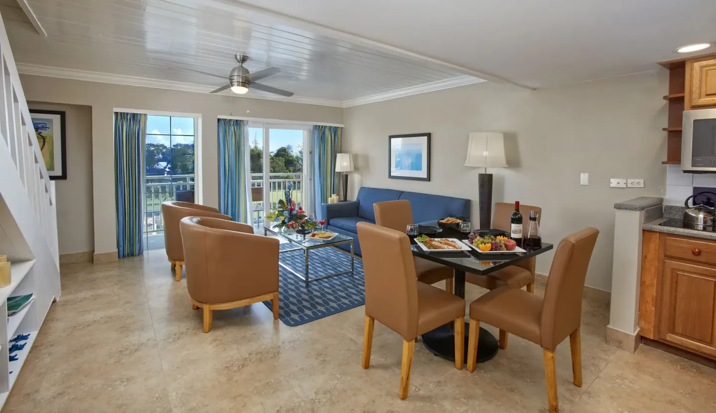 Two-bedroom suite living and dining area with kitchenette at Divi Southwinds Beach Resort.
