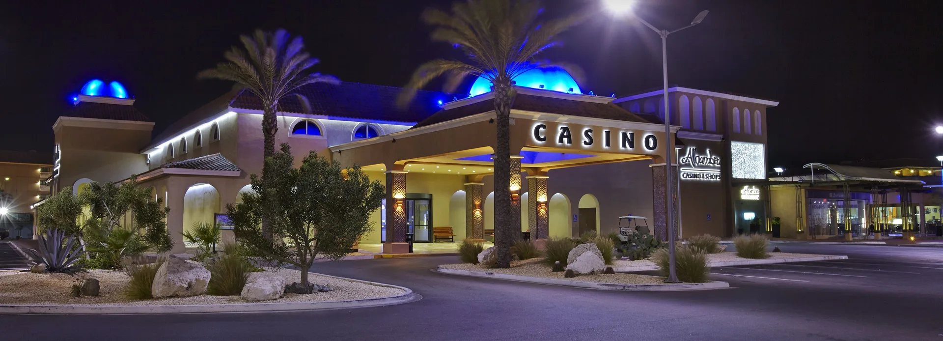 Illuminated casino exterior near Divi Village Golf & Beach Resort at night.