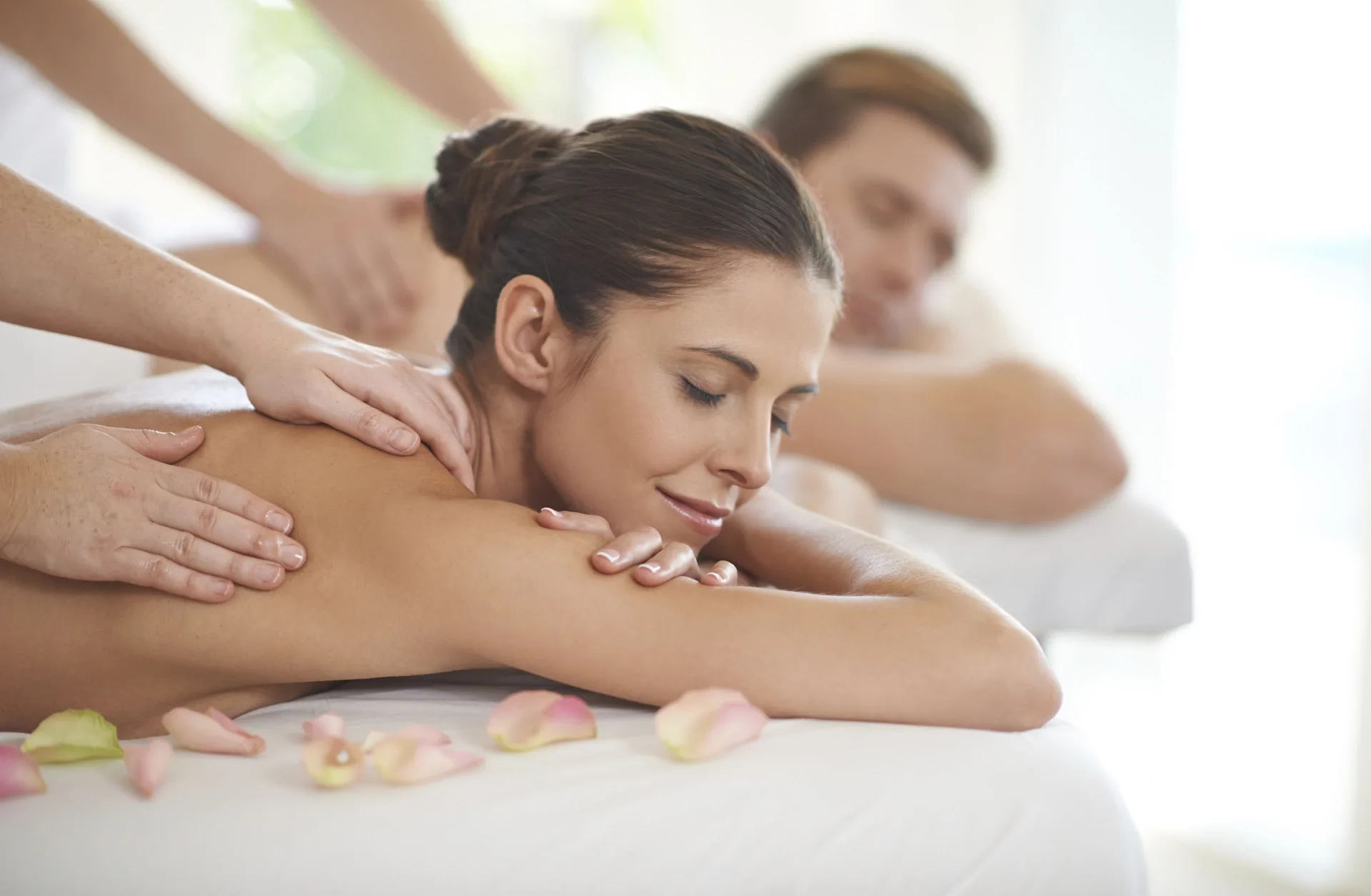 Couples massage with two guests on spa tables at Divi Village Golf & Beach Resort.