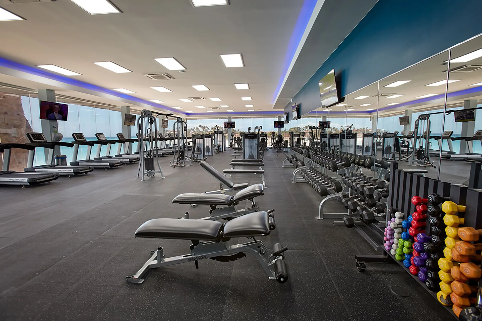Fitness center with benches, weights, and cardio machines at Divi Village Golf & Beach Resort.