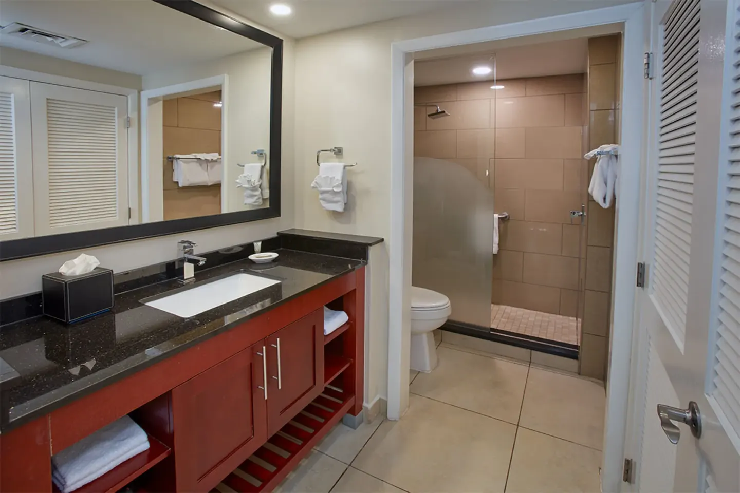 Guest bathroom vanity and glass shower at Divi Village Golf & Beach Resort.