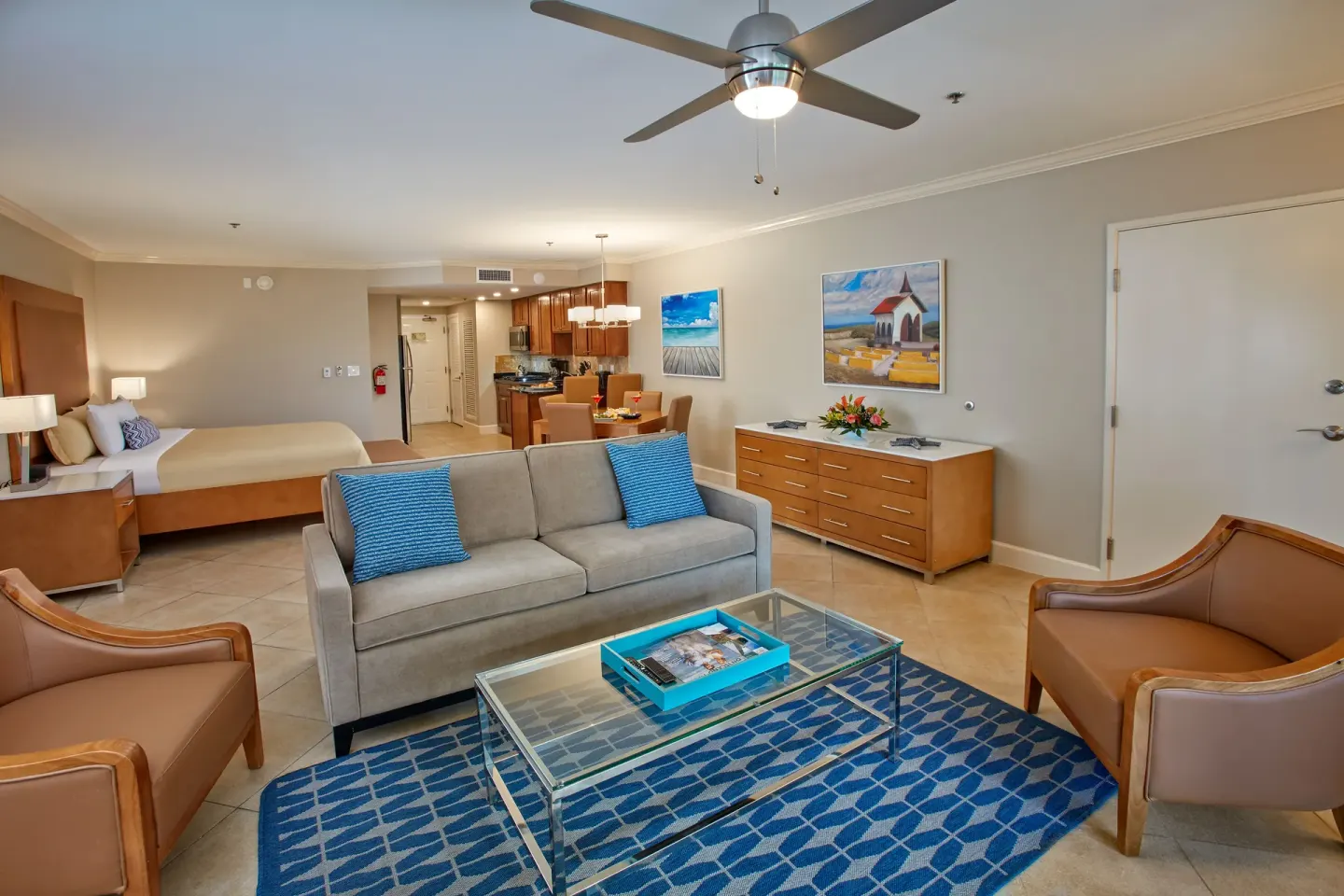 Studio-style suite with bed, sofa, chairs and kitchen at Divi Village Golf & Beach Resort.
