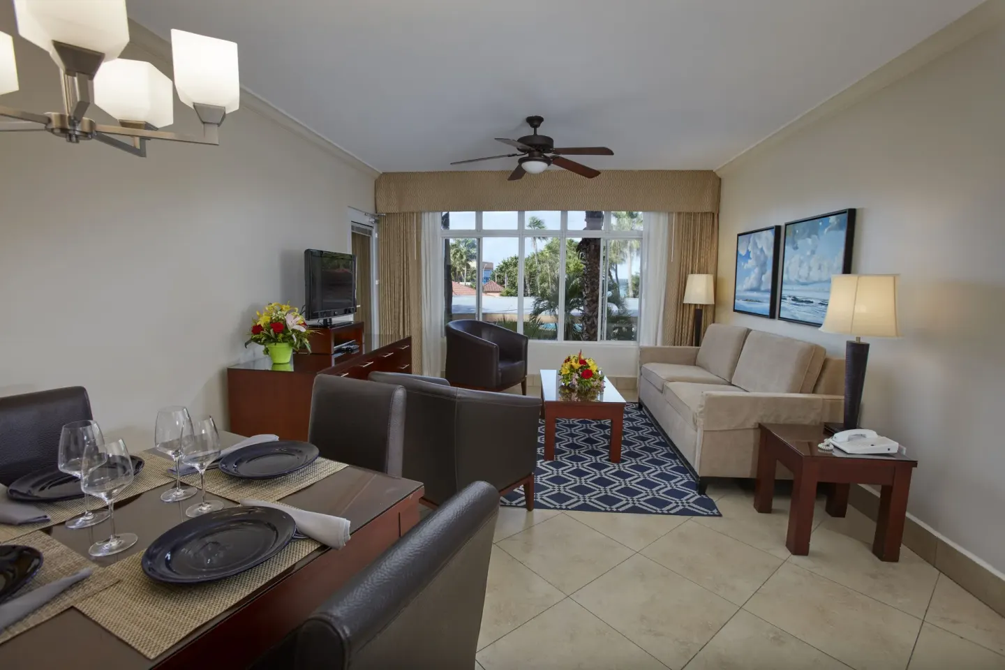 Suite living and dining room at Divi Village Golf & Beach Resort with garden-facing windows.