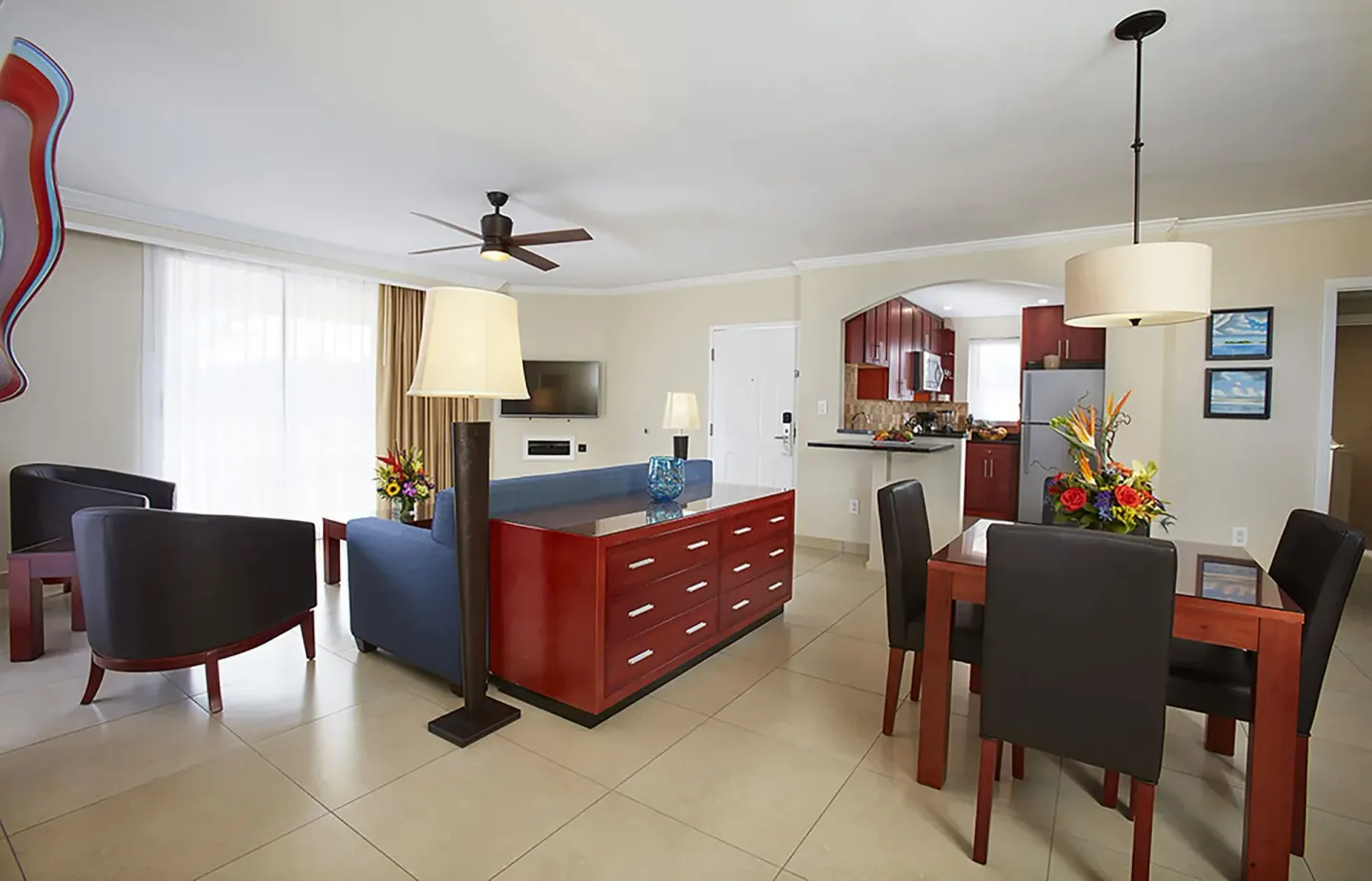 Suite living room with dining table and kitchen at Divi Village Golf & Beach Resort.