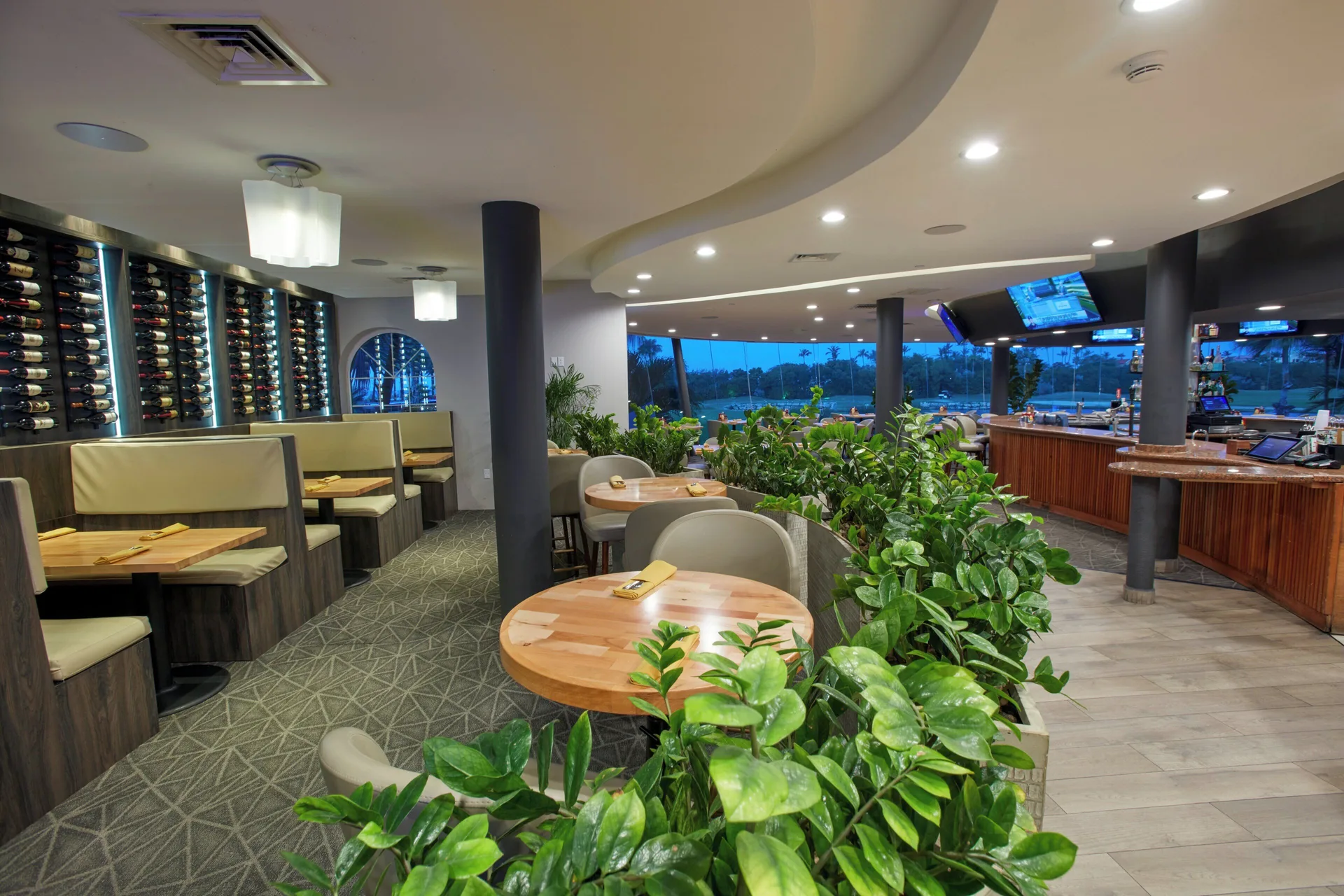 Indoor dining area and bar overlooking the pool at Divi Village Golf & Beach Resort.