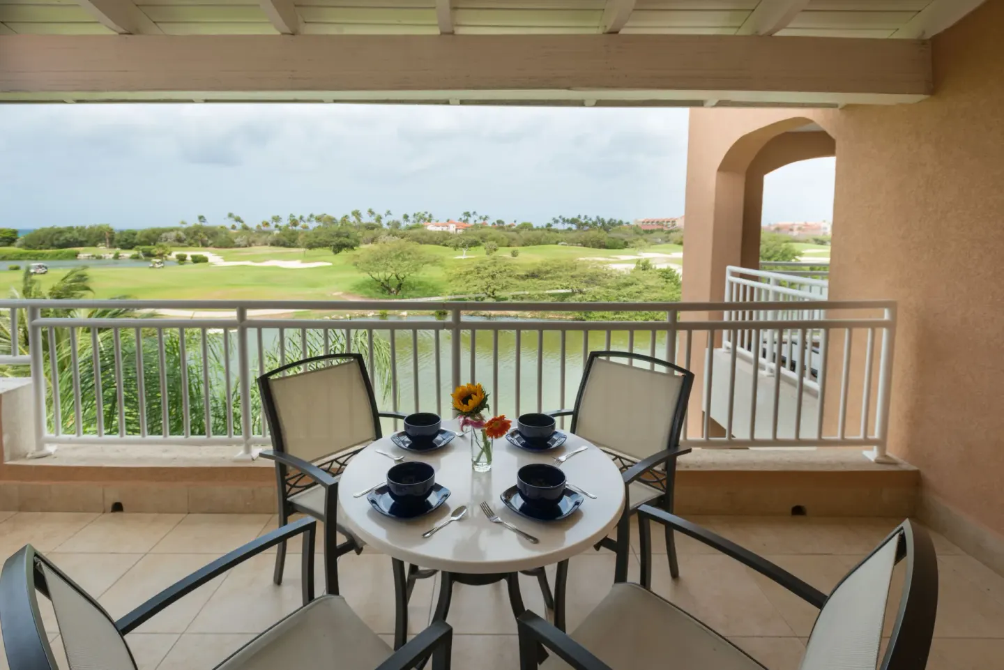 Golf Villa 1 Bedroom Suite balcony dining set overlooking golf course at Divi Village Golf & Beach Resort.