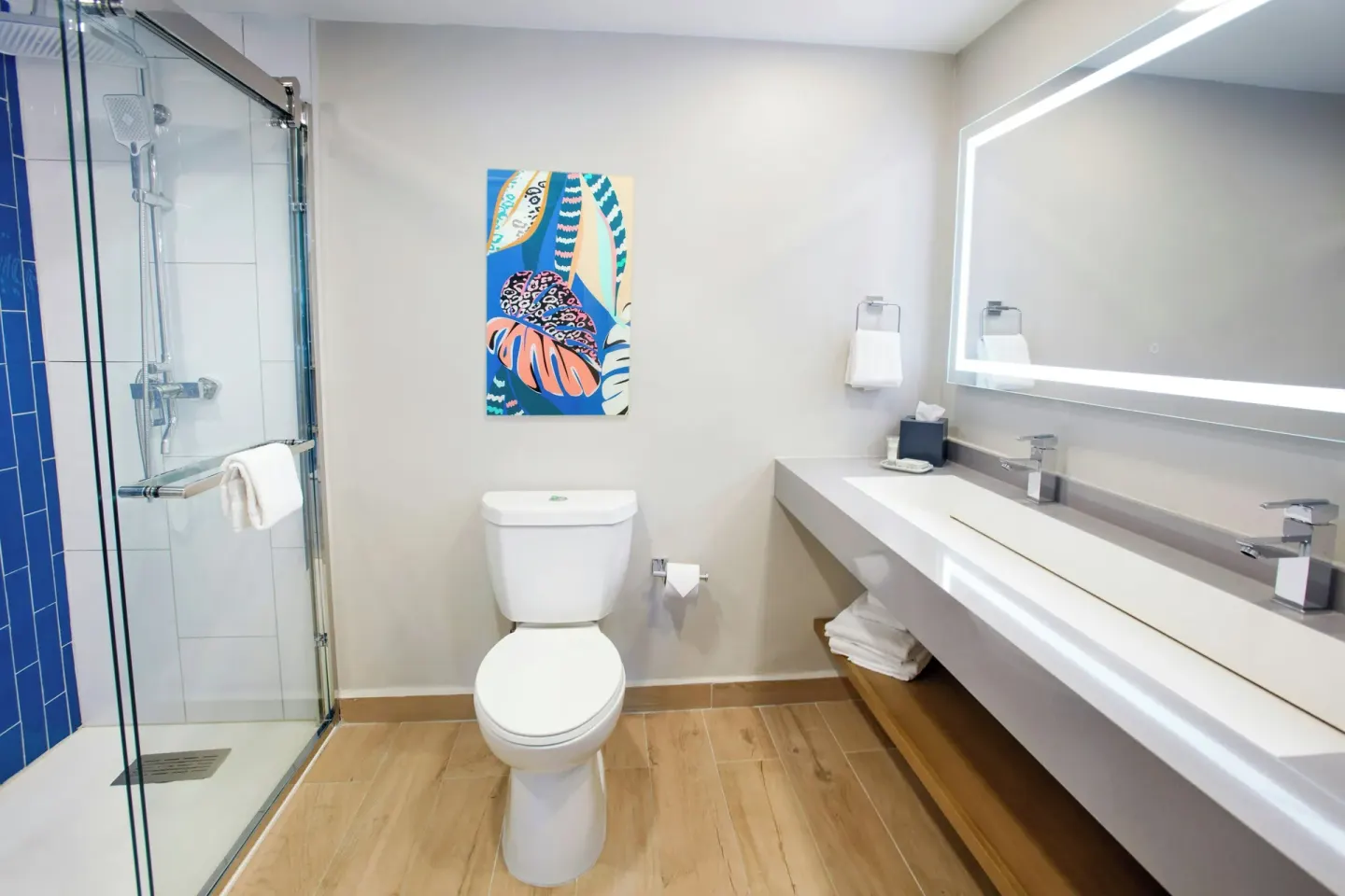 One Bedroom Suite bathroom with glass shower and double vanity at Divi Village Golf & Beach Resort.