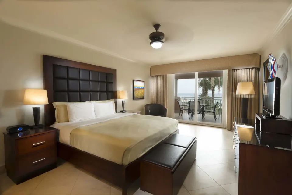 One Bedroom Suite king bedroom with balcony at Divi Village Golf & Beach Resort.