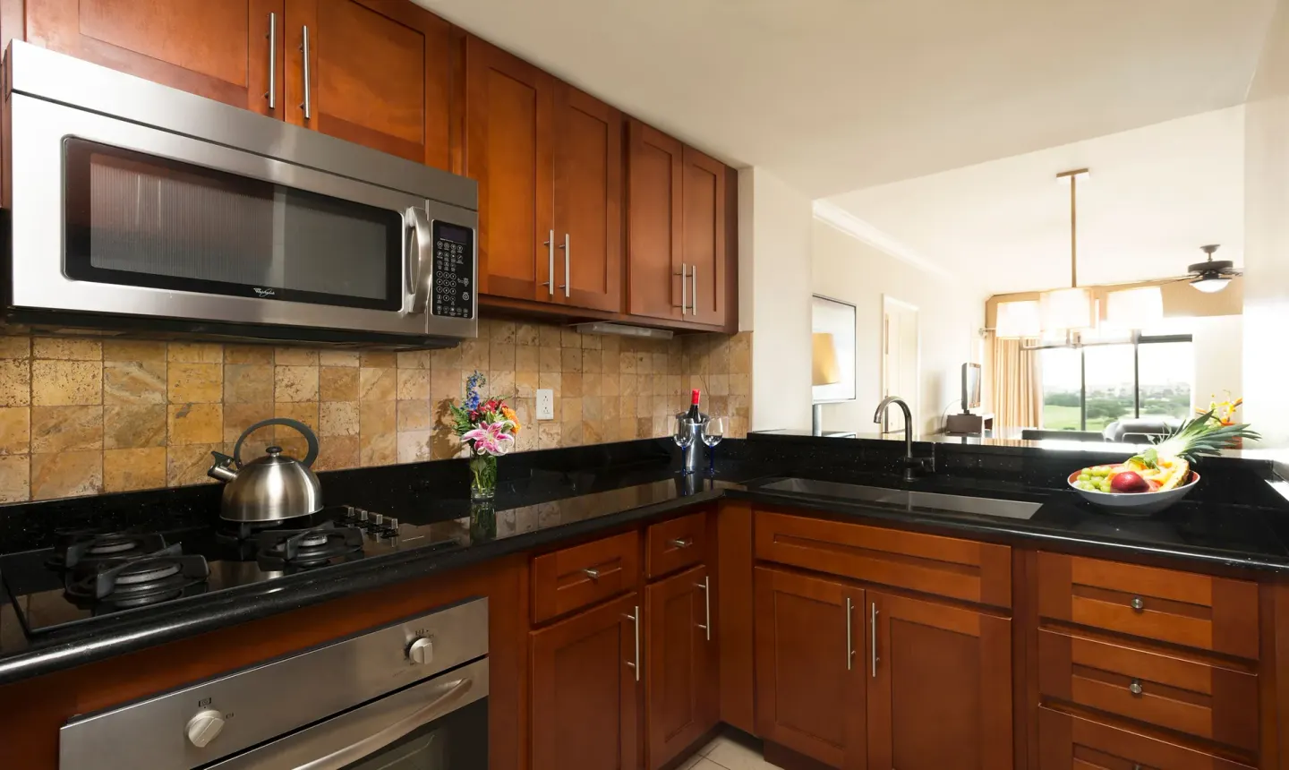 One Bedroom Suite kitchen with wood cabinets at Divi Village Golf & Beach Resort.