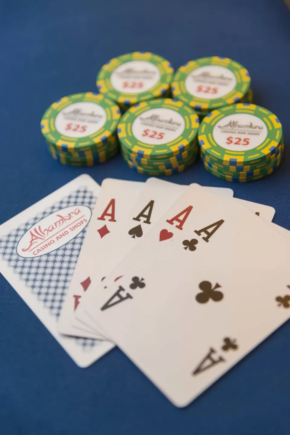 Playing cards and casino chips on a blue table at Divi Village Villas.