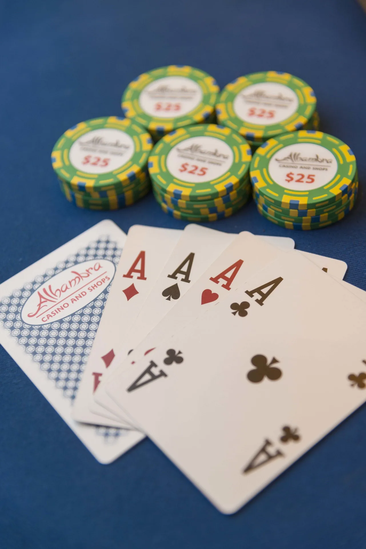 Playing cards and casino chips on a blue table at Divi Village Villas.