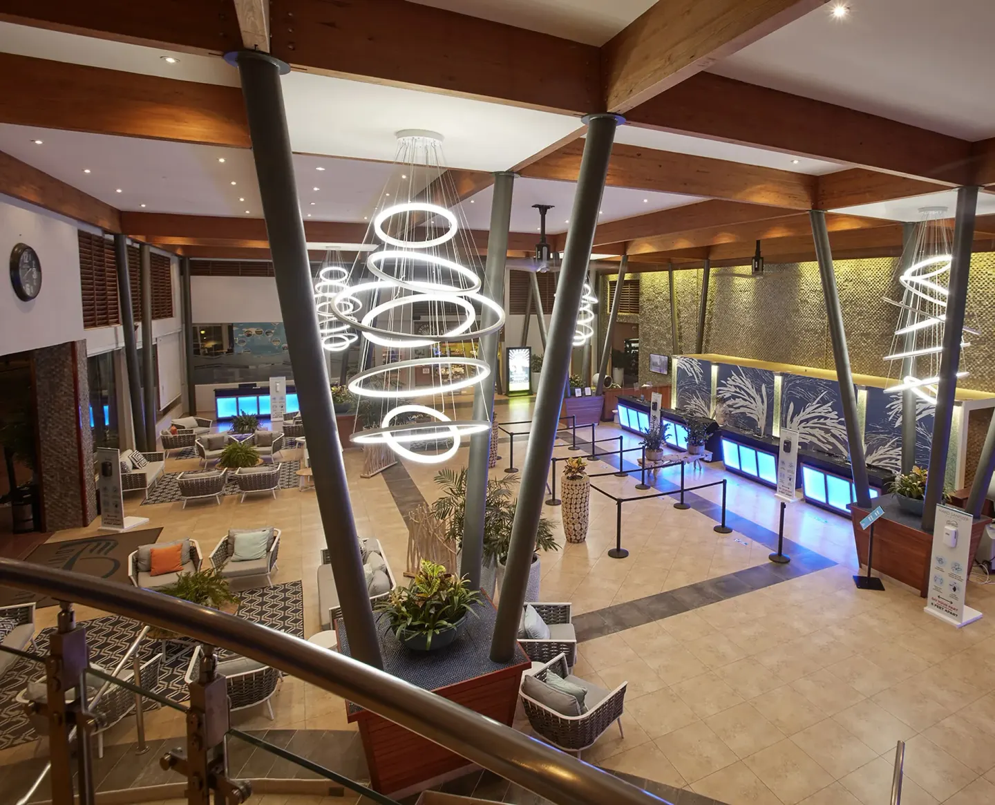 Elevated view of the lobby, reception counters, seating, and glowing lights at Divi Village Villas.