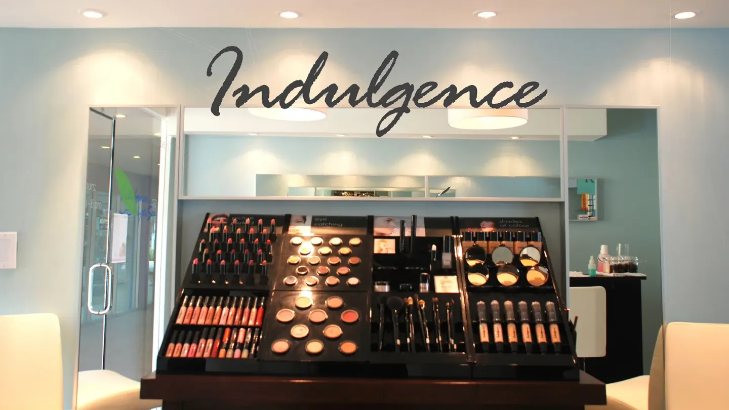 Makeup display beneath an Indulgence sign at Divi Village Villas.