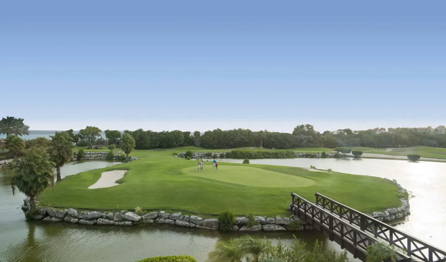 An island golf green with bridge and water features at Divi Village Villas.