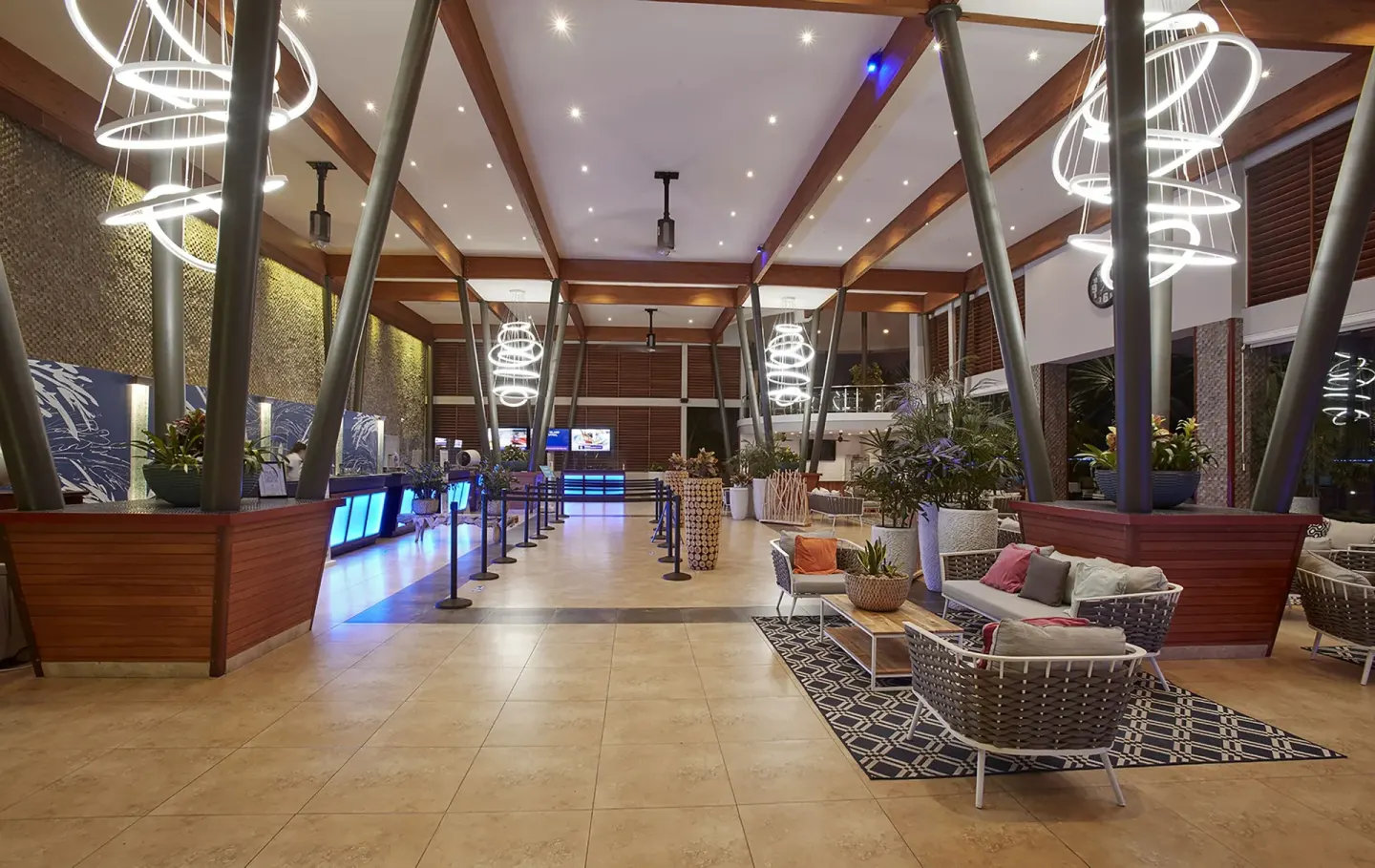 Lobby with reception counters, lounge seating, and ring lights at Divi Village Villas.