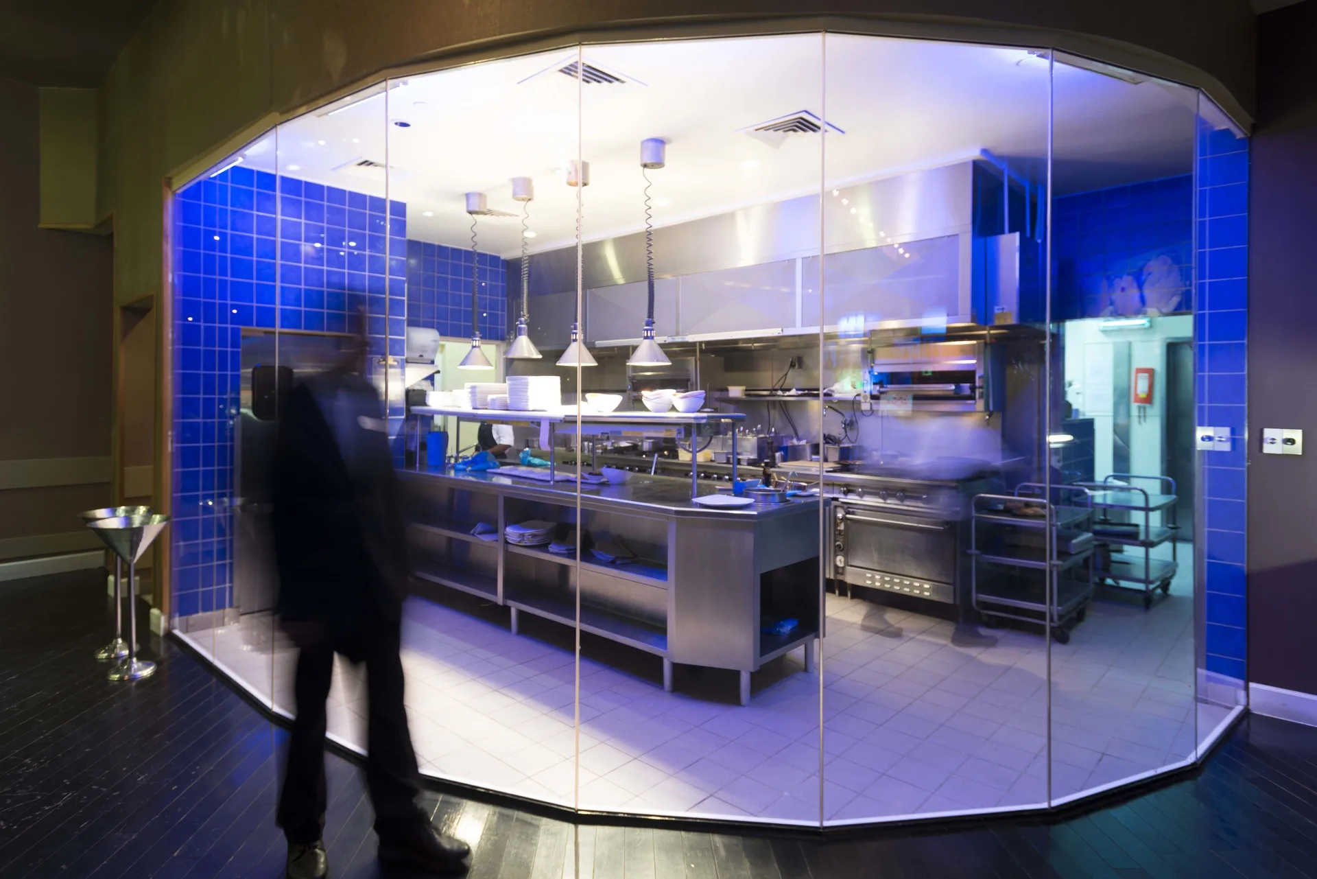 Glass-walled open kitchen with stainless workstations at Divi Village Villas.