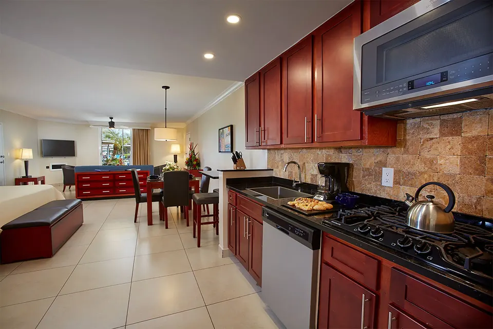 Kitchen in a Studio Suite Golf View at Divi Village Villas with cooktop, microwave and dining area.