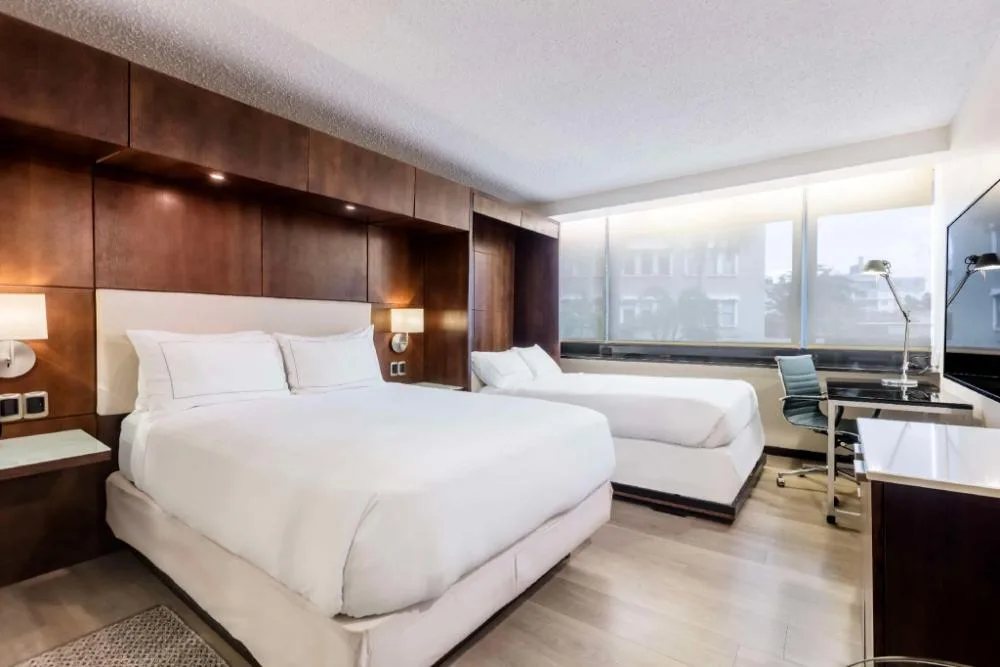 Murphy Garden View room with bed, daybed, desk, and large windows at DoubleTree San Juan.