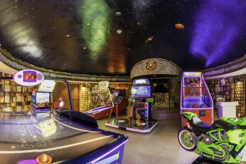 Arcade room with air hockey and video games at Dreams Riviera Cancun Resort & Spa.