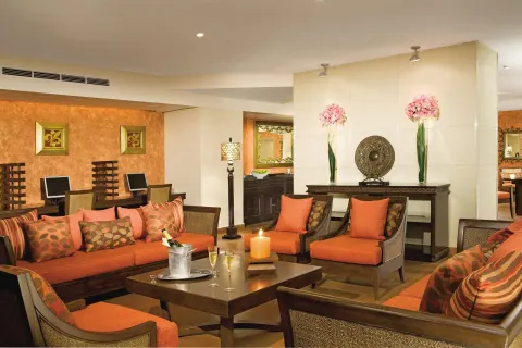 Orange lounge seating and computer stations at Dreams Riviera Cancun Resort & Spa.